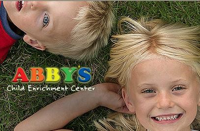 Two kids laying on the ground