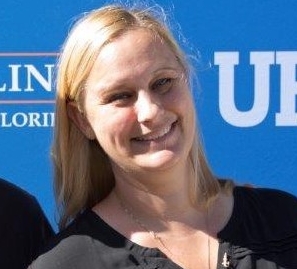 Photo of Dr. Crystal Marull smiling with a blue background 