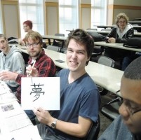 Student holding up picture of Asian vocabulary