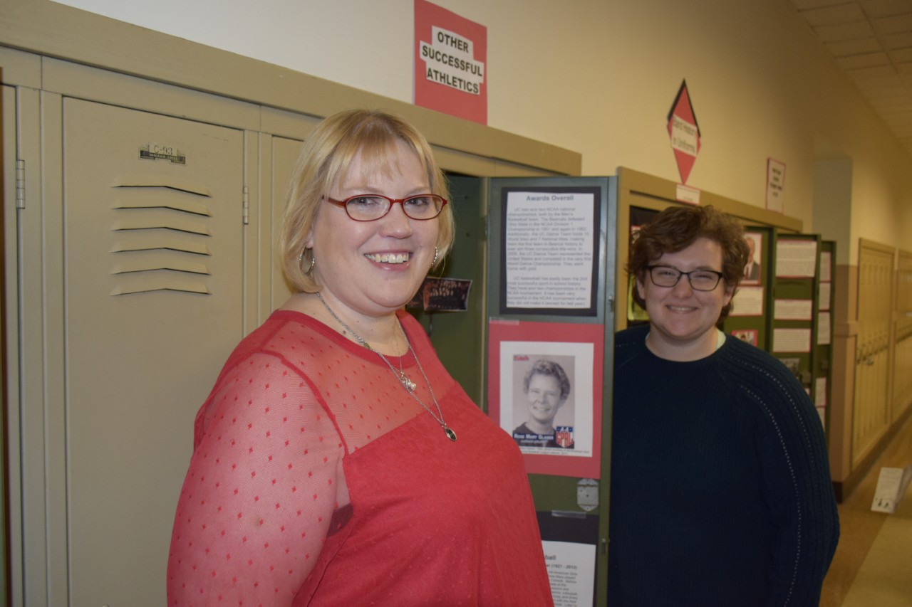 Two students standing in front of locker exhibits