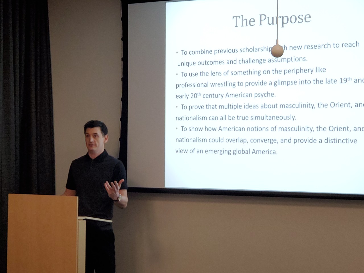 UC graduate student presenting his research in QCC 