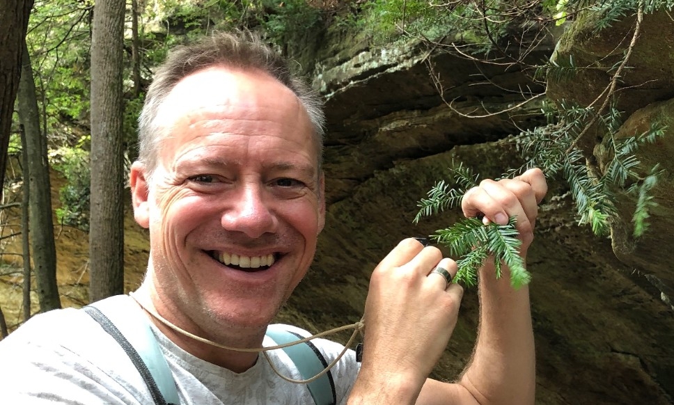 Prof. Tepe in the woods examining leaves