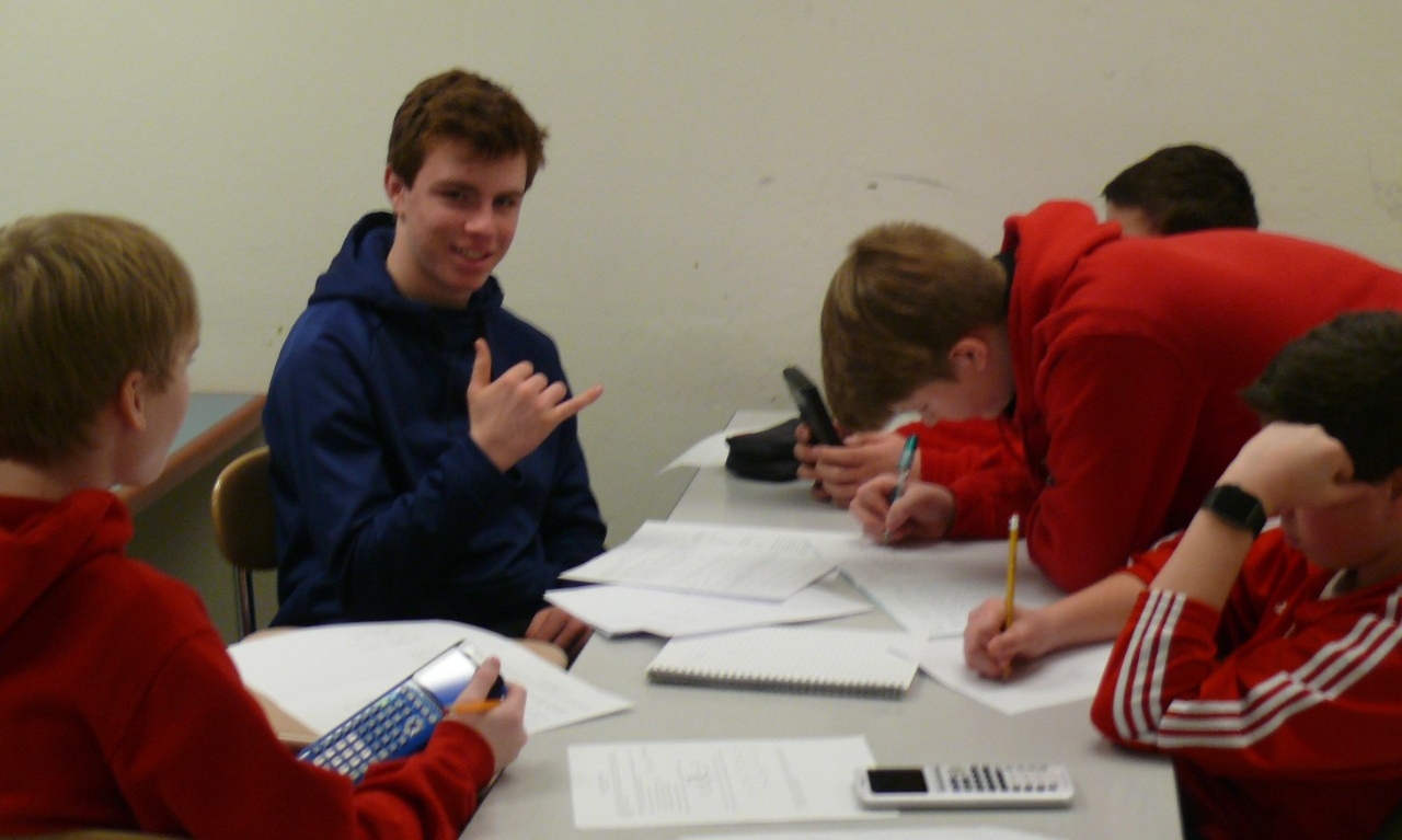 Math Bowl 2018 students working a grouped desks