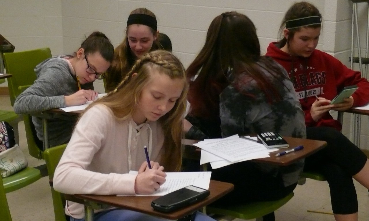 Math Bowl 2018 students working a grouped desks