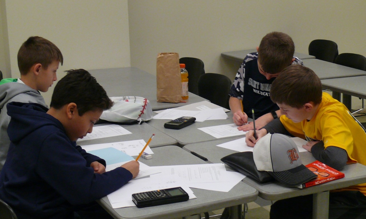 Math Bowl 2018 students working a grouped desks