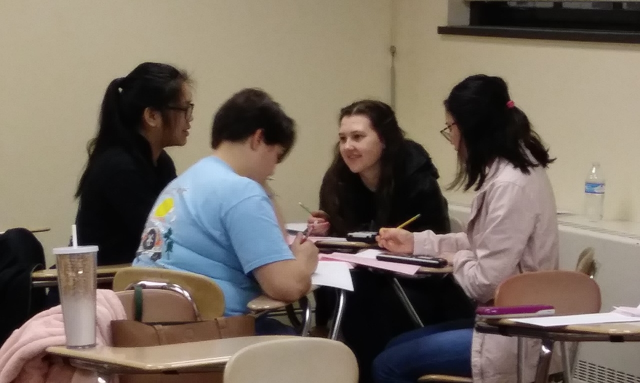 Math Bowl 2019 students working a grouped desks