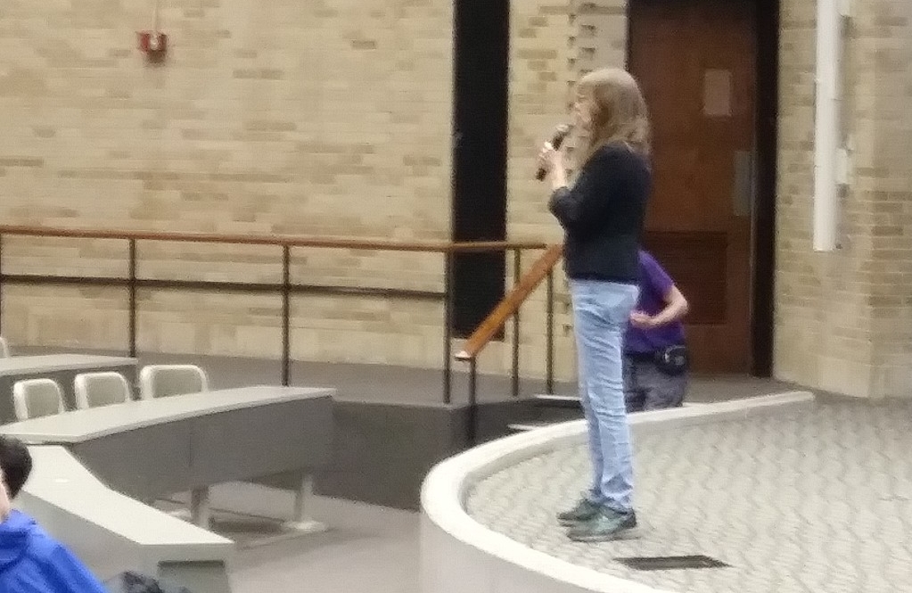 Math Bowl 2019 professor speaking at front of lecture hall