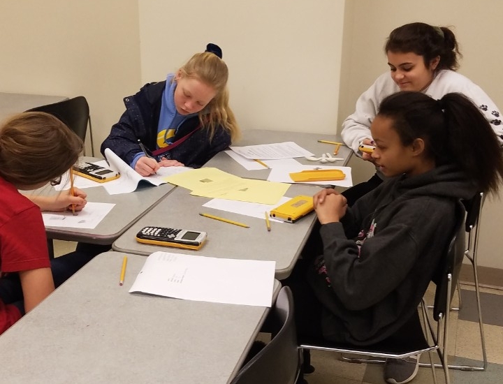 Math Bowl 2019 students working a grouped desks