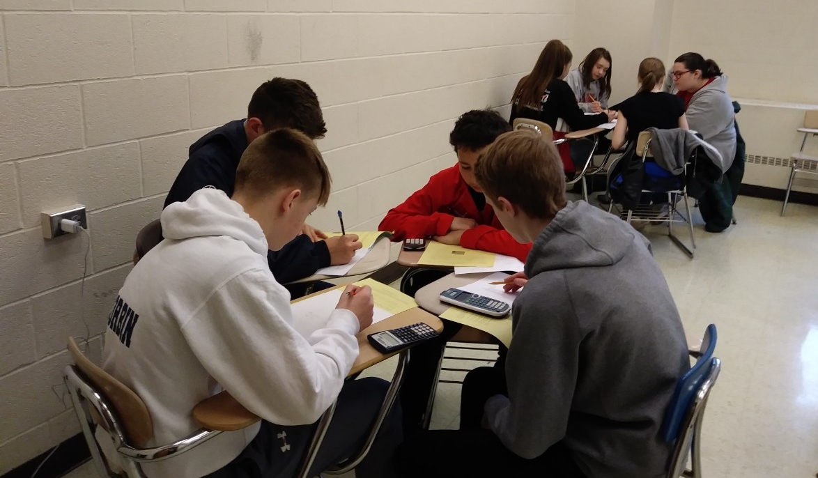 Math Bowl 2019 students working a grouped desks