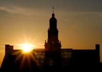 Photo of McMicken hall with the sunset in the background