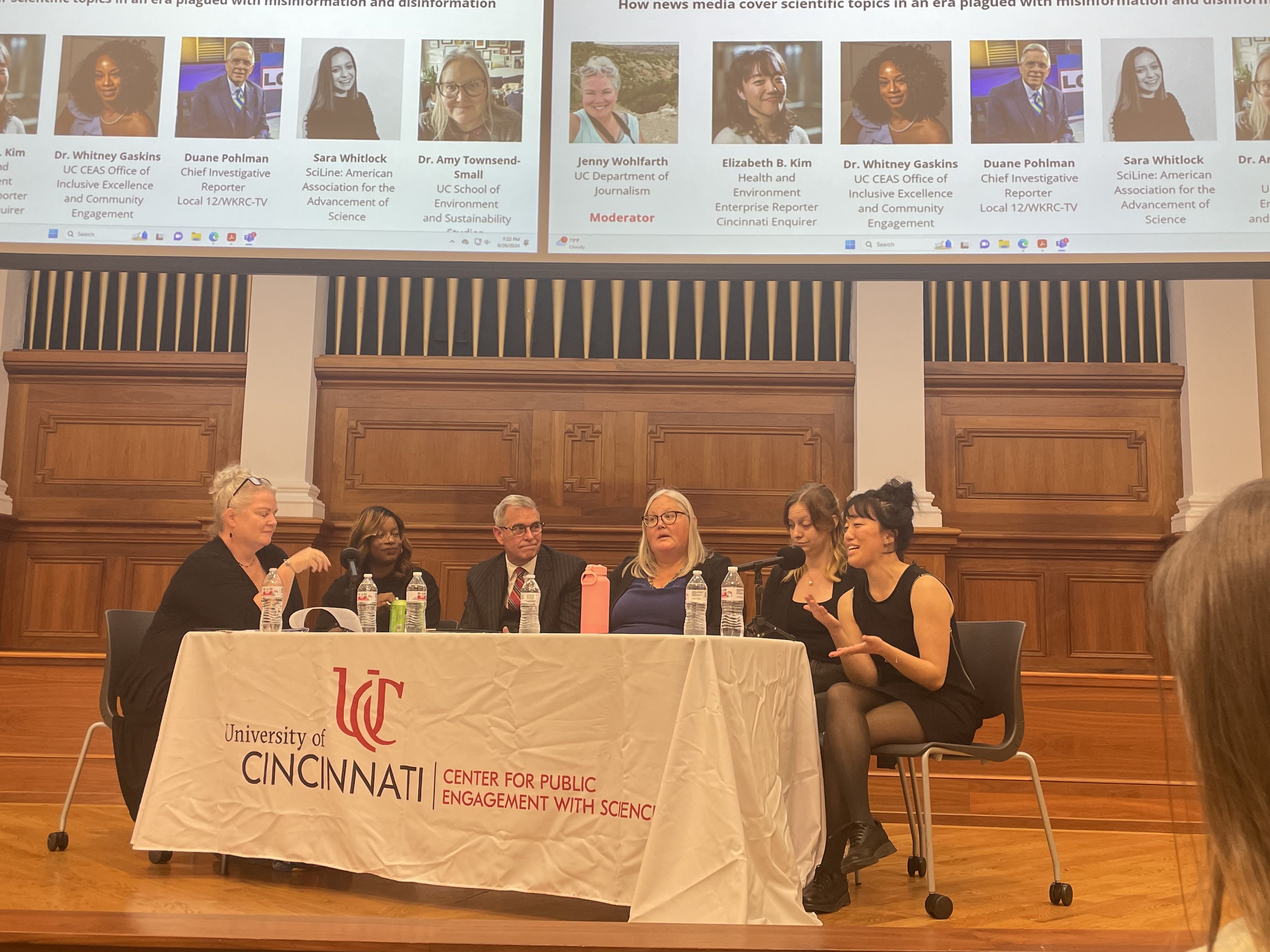 Panelists sit around a table.