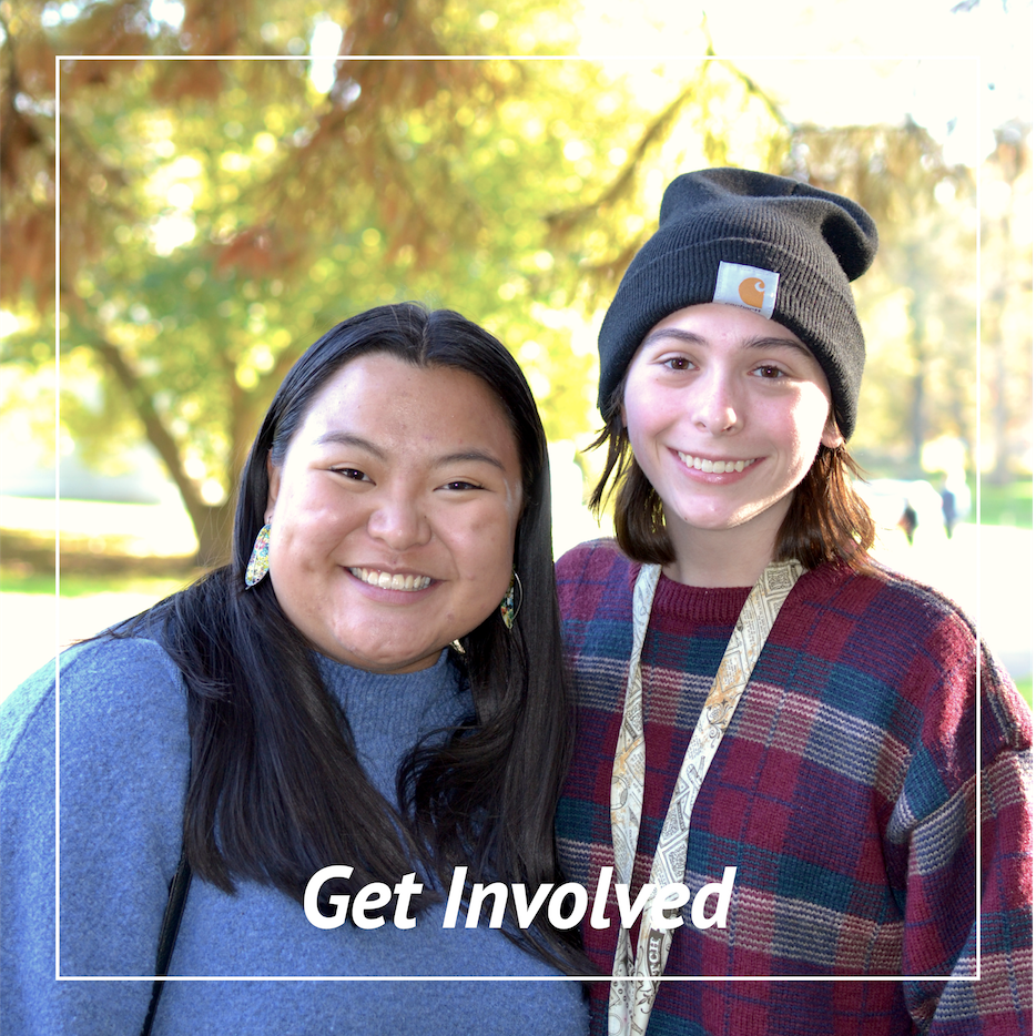 Two students smiling at an outdoor event