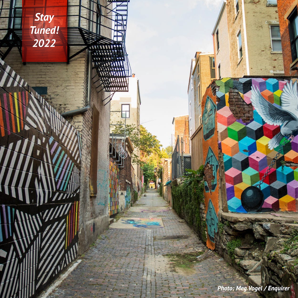 View down Historic Bolivar Alley with street murals and colorful graffiti