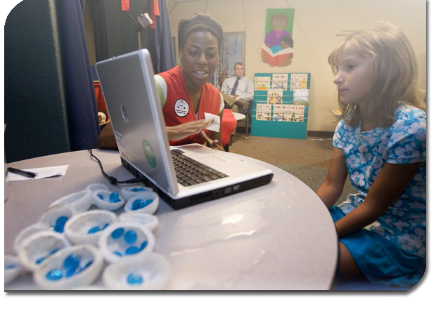 Student and teacher looking at laptop