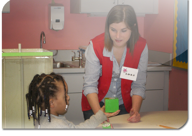 Teacher watches as child plays with cubes