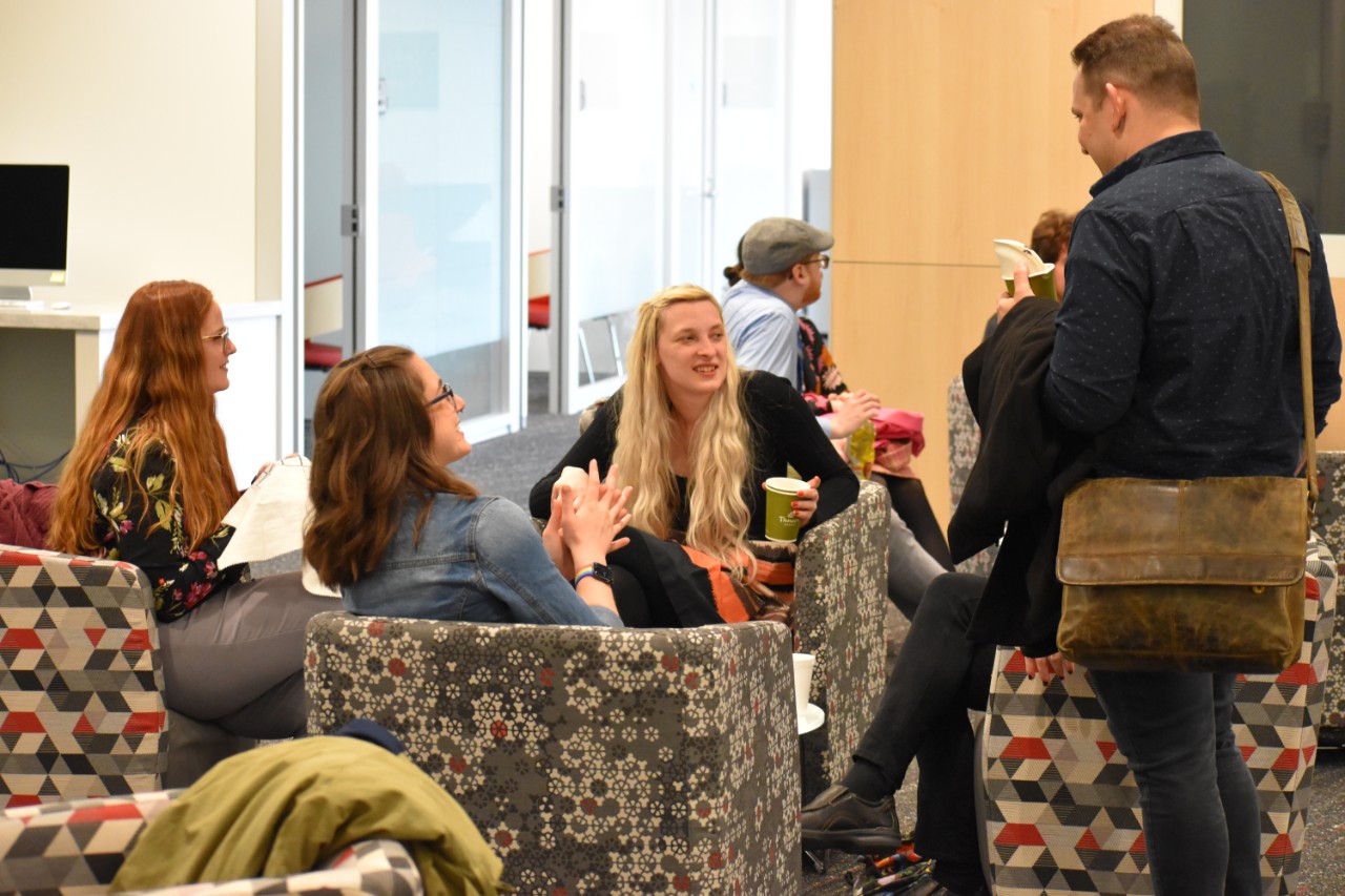 history graduate students chatting on the sofa