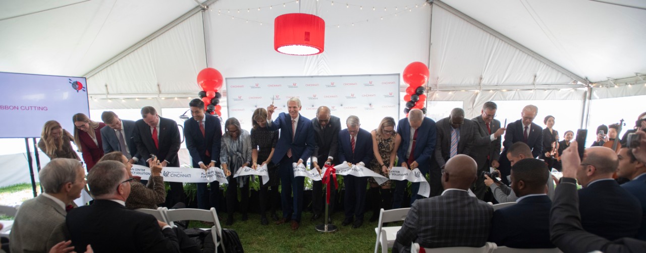 Left to right Sally Portman, Mackenzie Collett, UC student speaker, Andrew Lewis, PhD, Associate Professor, School of Public & International Affairs, University of Cincinnati, Phil D. Collins, Chair, Board of Trustees, University of Cincinnati, Aftab Pureval, Mayor, City of Cincinnati, Valerie Lemmie, Senior Advisor, State and Local Government, Kettering Foundation, Jane Portman, Rob Portman, Senator, United States of America (OH), Dr. Neville G. Pinto, president of University of Cincinnati, Mike DeWine, Governor, Ohio, Senator Kyrsten Sinema, AZ, Provost Valerio Ferme, PhD, James Mack, PhD, Dean, College of Arts & Sciences, Richard J Harknett, Director & Professor, School of Public & International Affairs and UC Foundation President Peter Landgren cut the ribbon during Portman Center for Policy Solutions in the tent on Bearcat Commons Monday October 23, 2023. Photos by Joseph Fuqua II